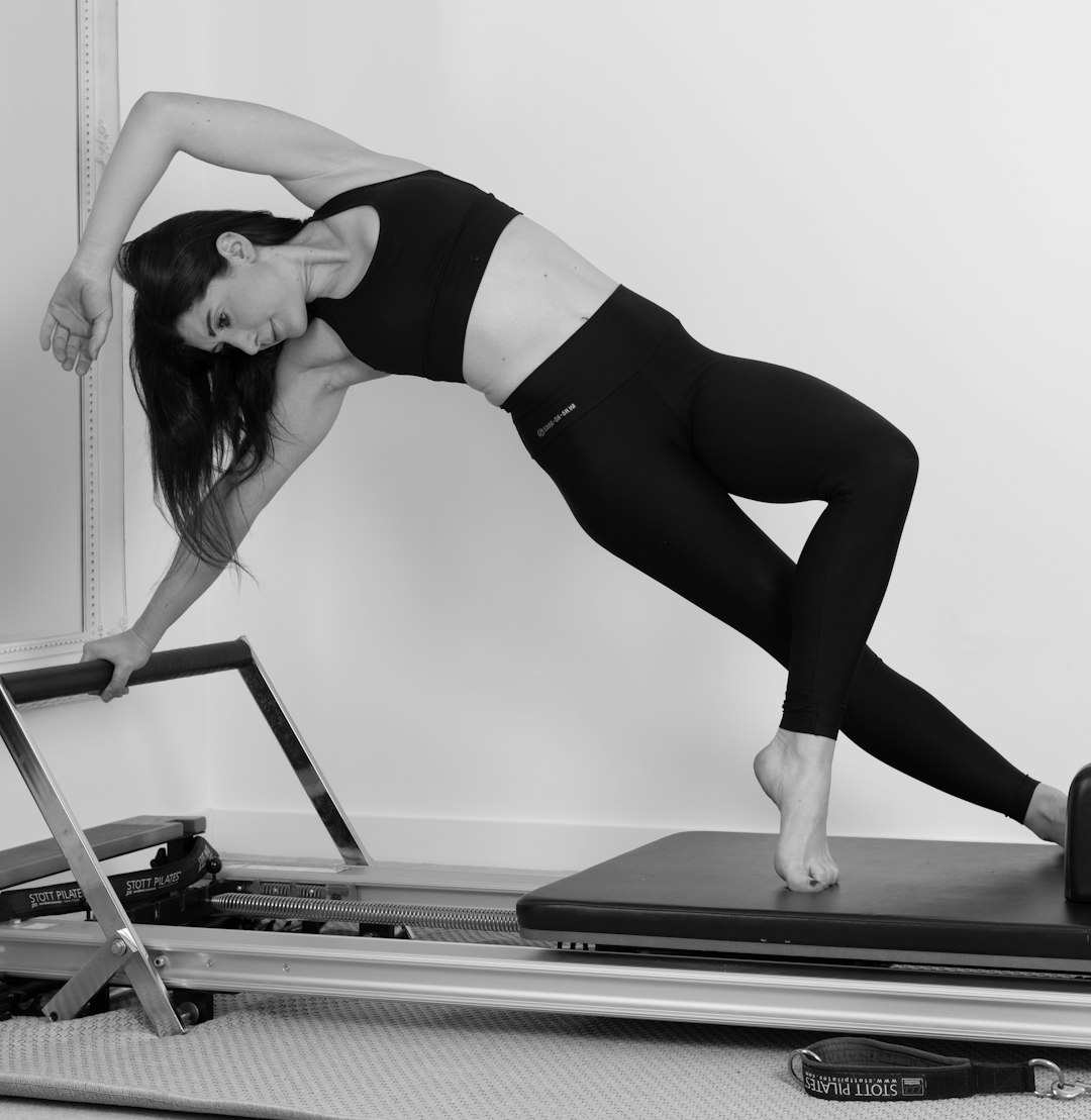 Athlete stretching on a Pilates reformer